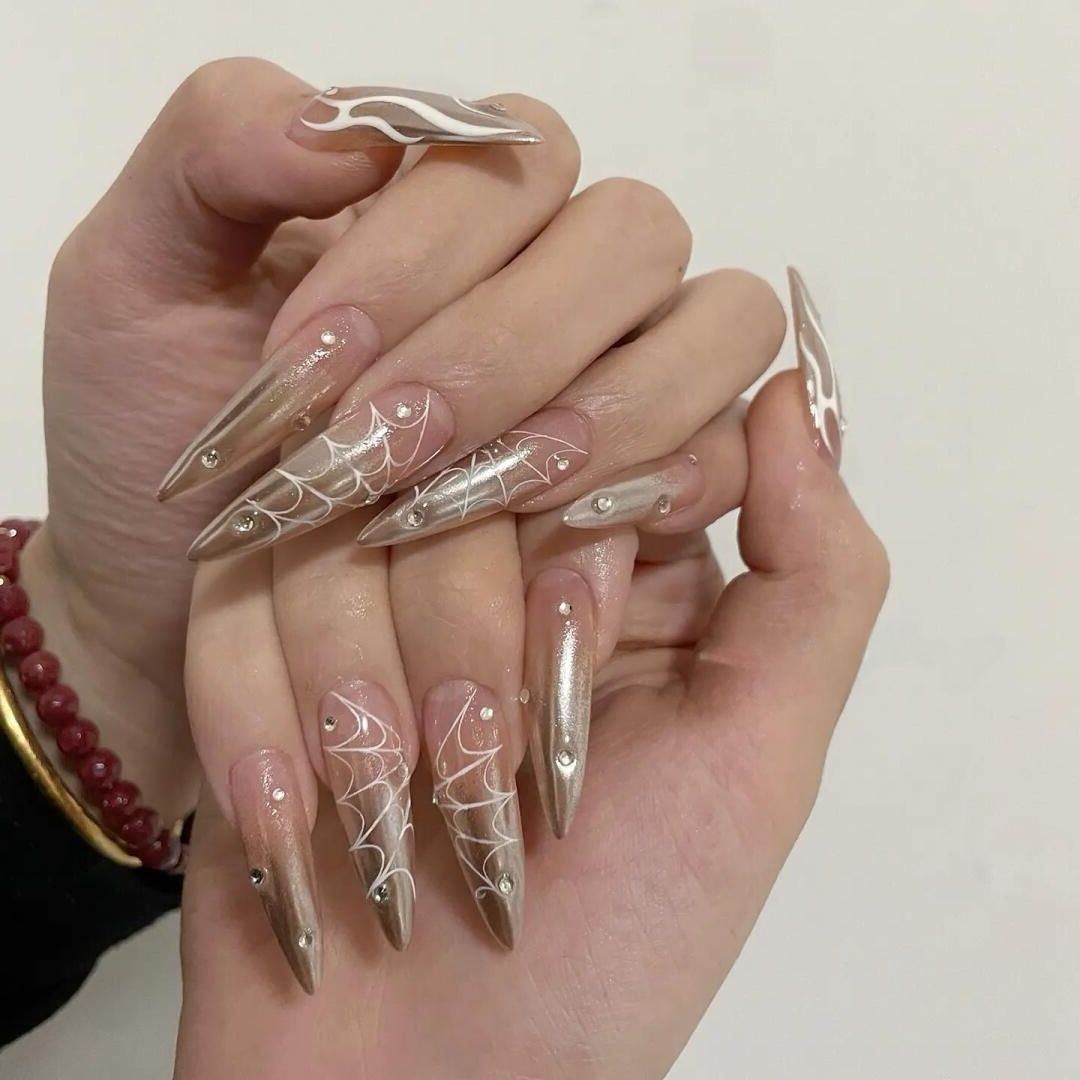 Luxury Metallic Gold Spiderweb Stiletto Nails – Glamorous Design with Rhinestone Accents!